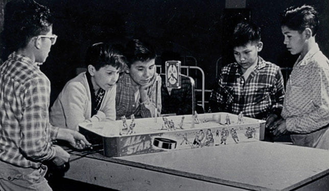 Junior boys playing table hockey,